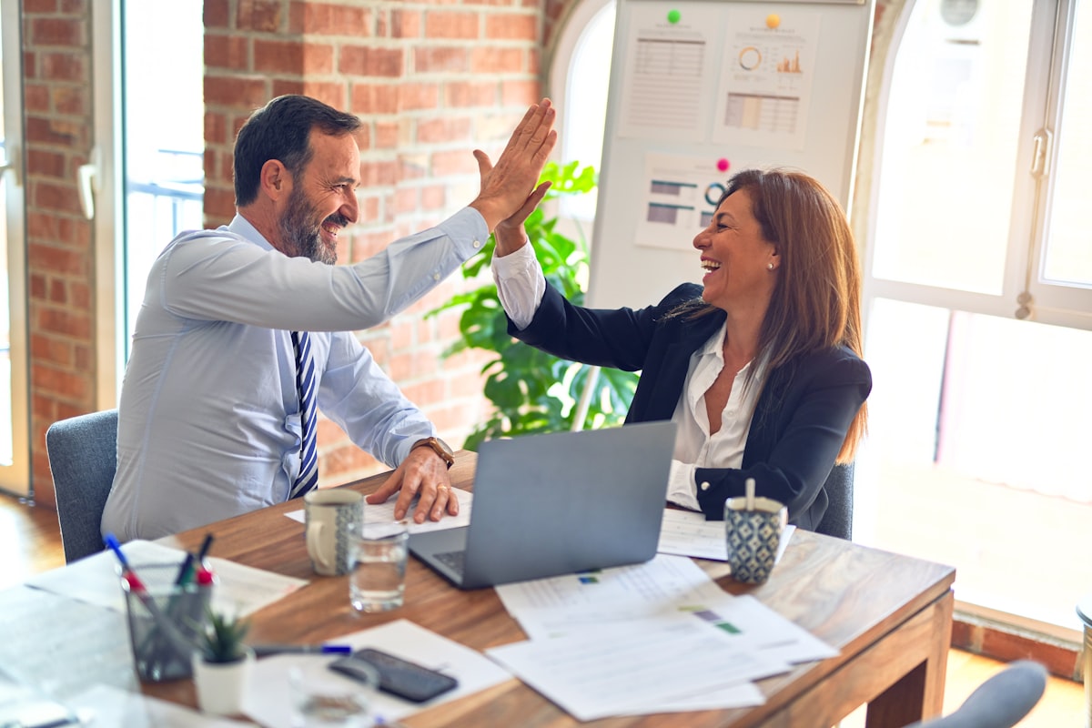 Two colleagues celebrating a good meeting with a high-five