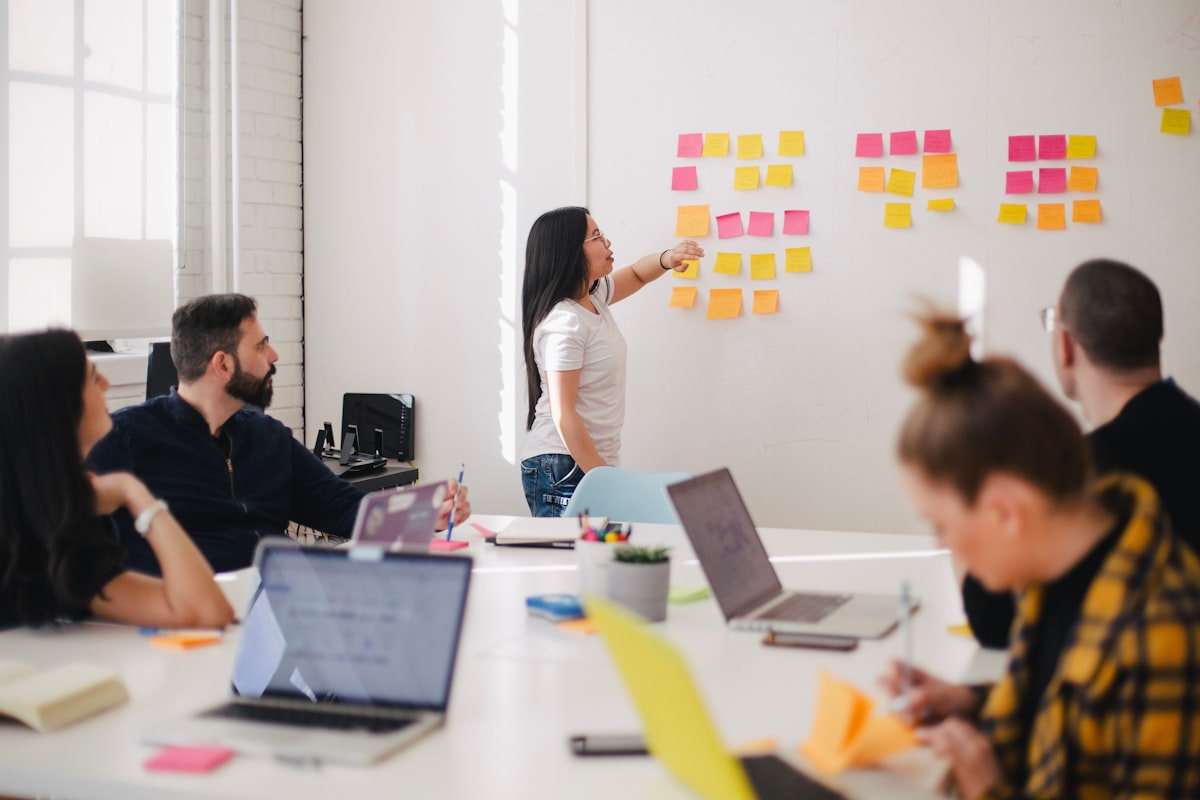 A team in a workshop, mapping ideas out on sticky notes